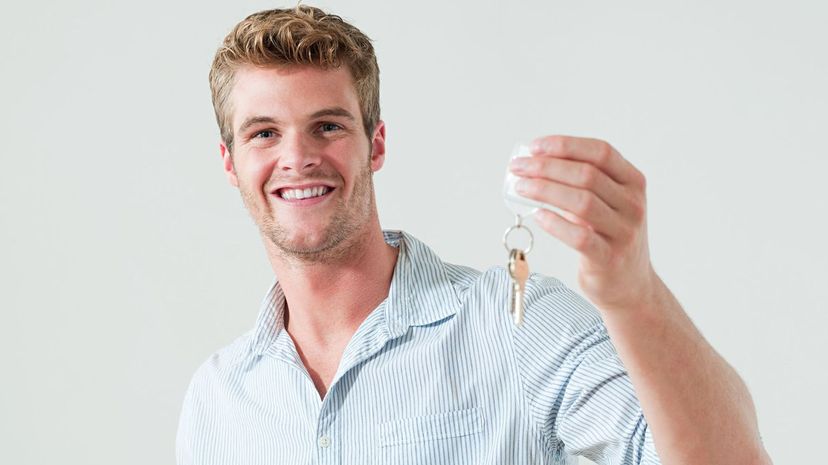 Young man holding house keys