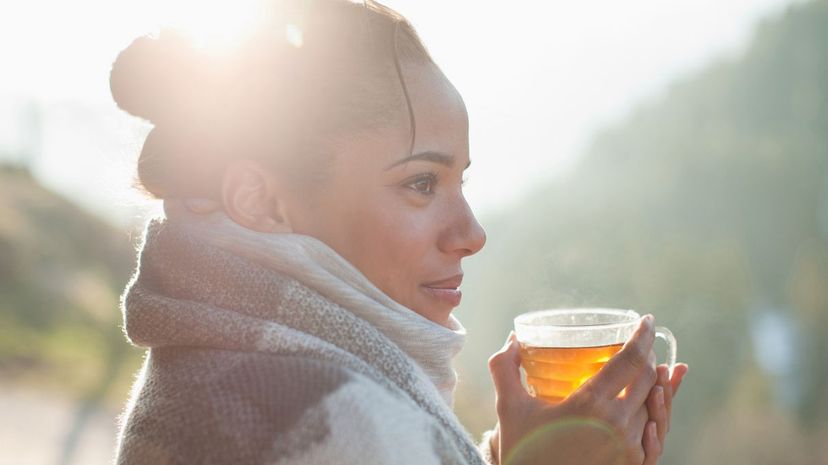 woman drinking tea outdoors