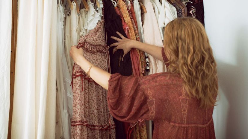 Woman choosing clothes from wardrobe