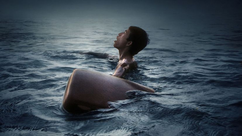 Man with suitcase in ocean