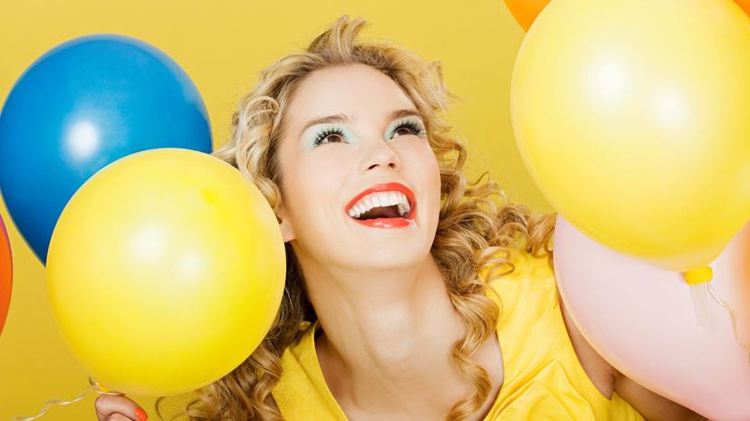 Young blonde woman with balloon