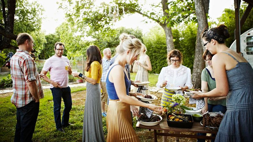Group of friends in backyard dishing up food