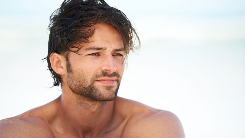 handsome man looking away wind blown hair brown scruffy