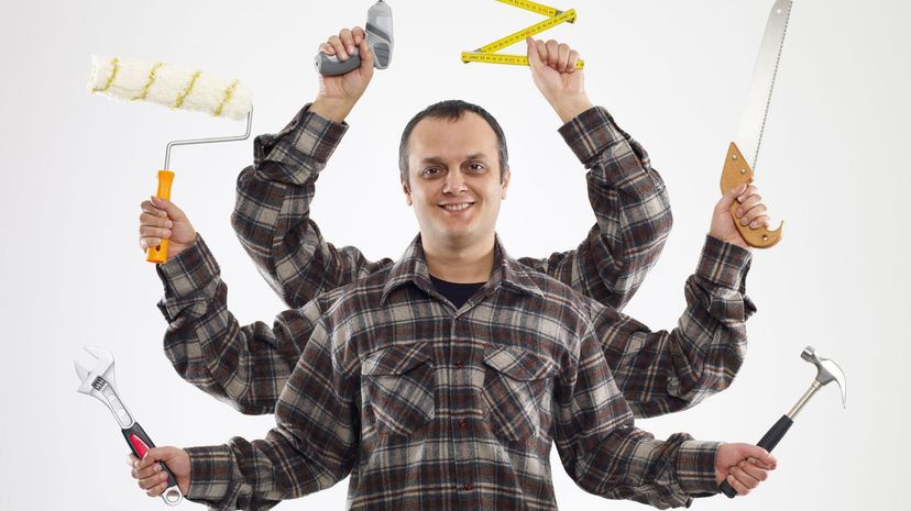 Handyman with six arms holding assorted tools