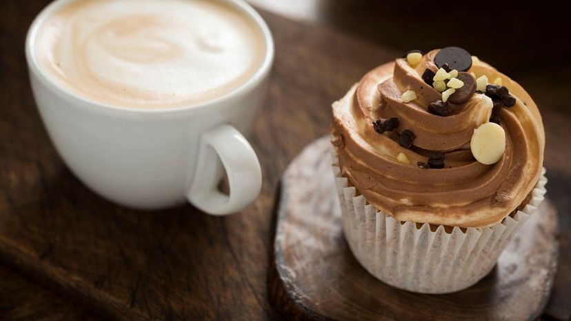 Latte coffee and a triple chocolate cupcake