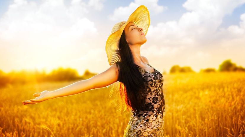 Woman in wheat field taking in some fresh air