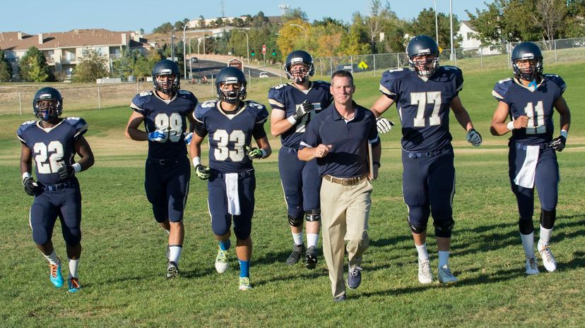 Teenage and young adult american football training with coach