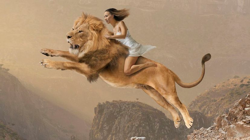 Girl riding lion jumping on mountain