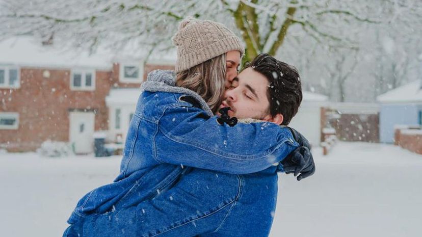 Couple kiss snow