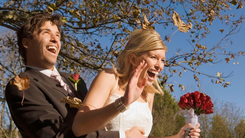 A wedding couple in an autumn wind