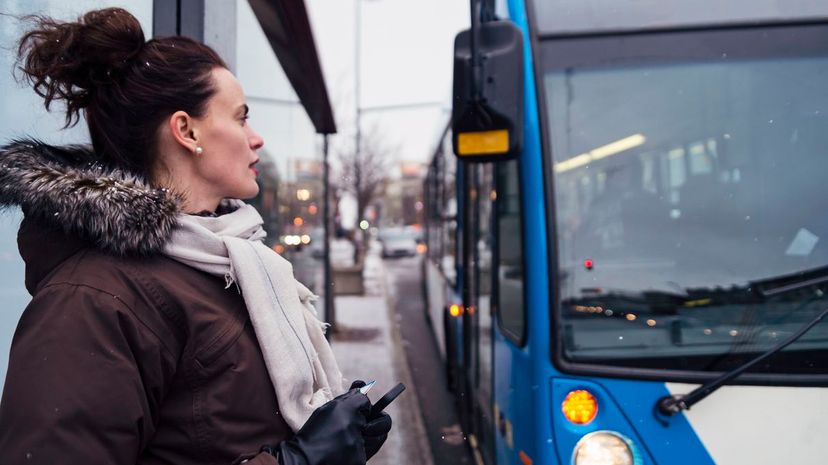 Woman getting ready to step on bus cummuting in winter