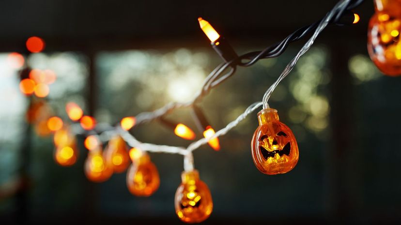 Pumpkin electric light string against the window