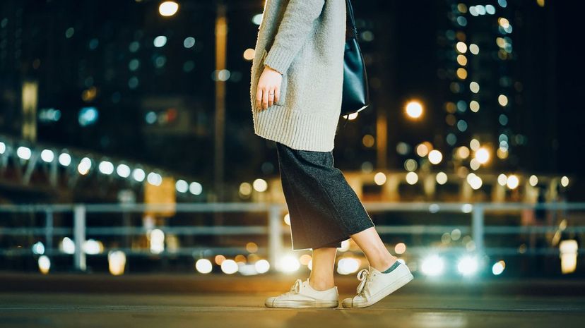 Woman walking in the city at night