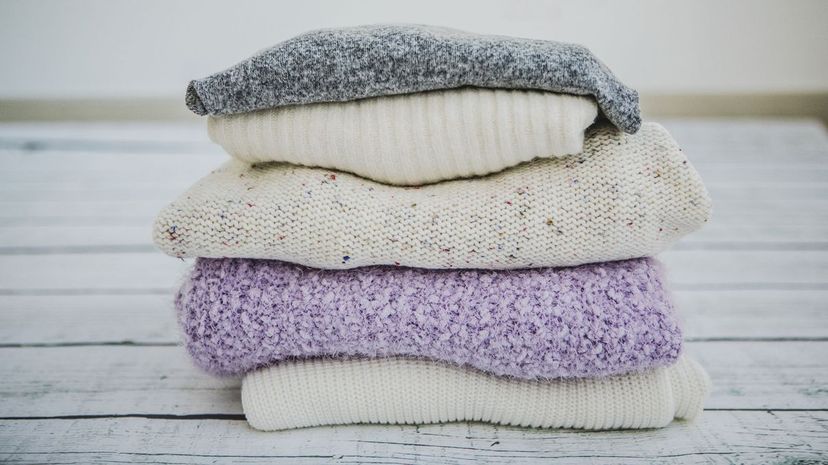 Variety of sweaters piled up