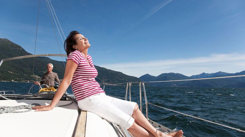 Older couple relaxing on sailboat