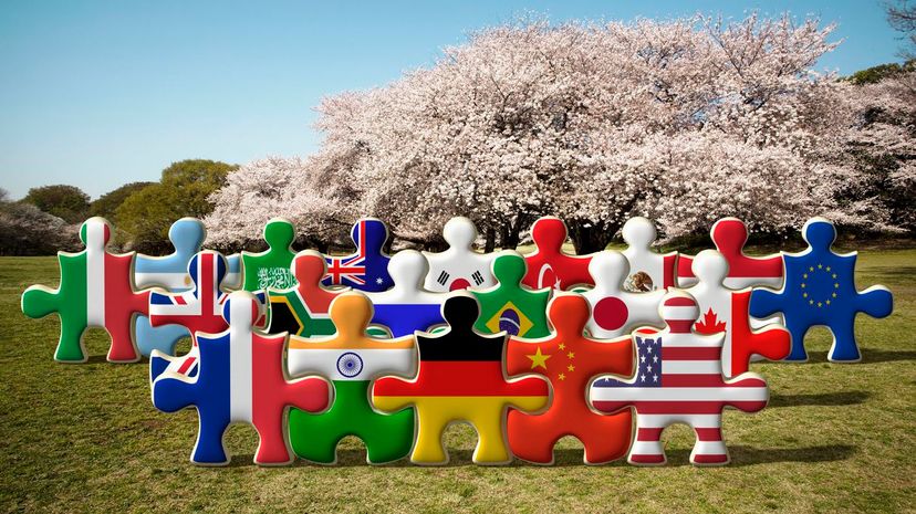 Puzzles of national flags holding hands in a row