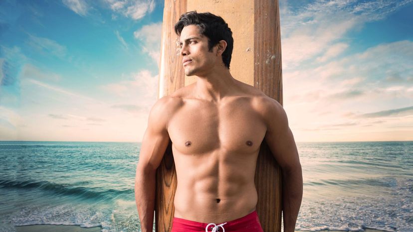 handsome latin man bathing trunks surfboard beach