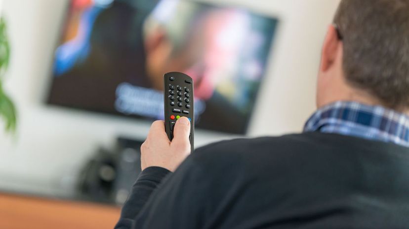 Man using TV Remote Control