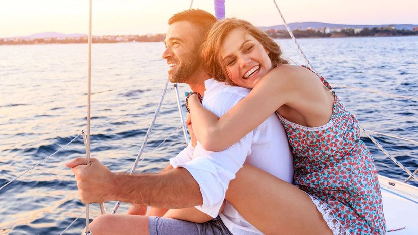 Couple having romantic trip with yacht in sea