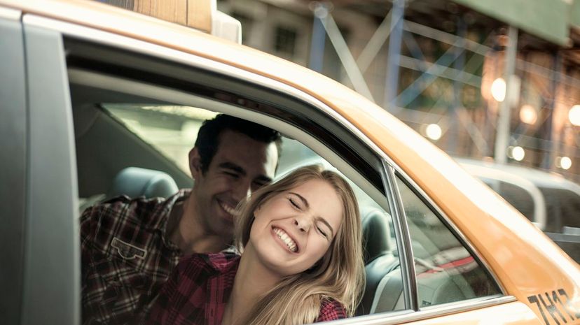 Couple laughing in taxi