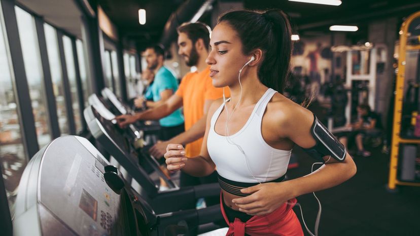 Young woman exercising on treadmill