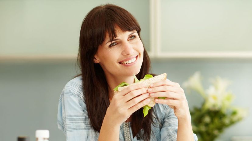 Woman eating fresh healthy sandwich