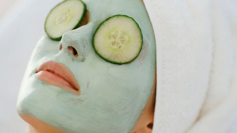 Woman Lying Down With a Face Pack and a Towel Wrapped Around Her Head