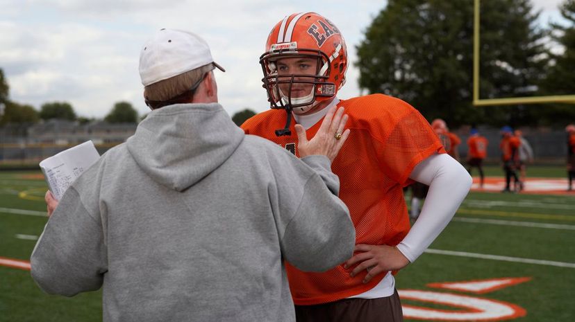 American football player talking with coach