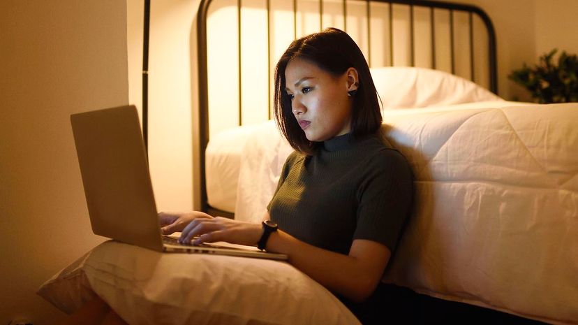 Woman working from her laptop at home late at night