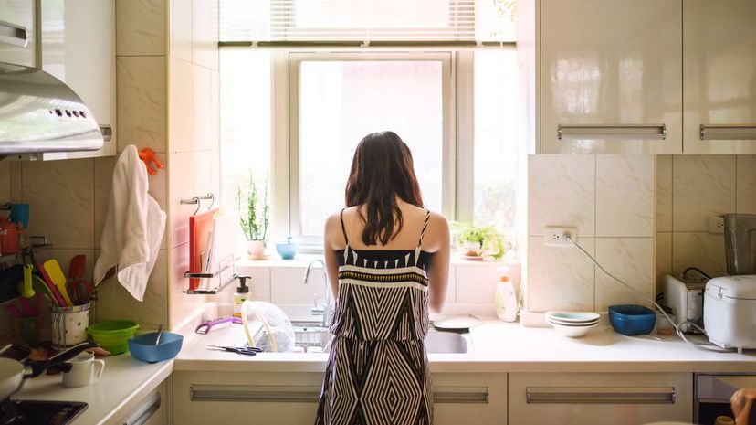 Teenage girl washing dishes