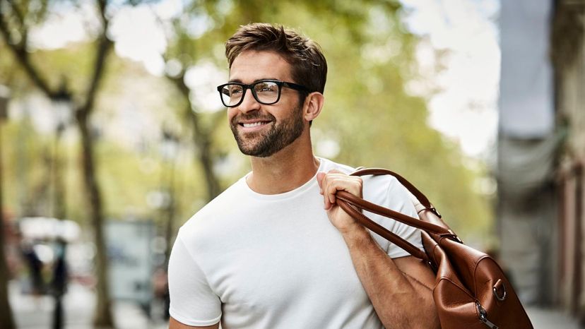 atttractive man beard with glasses carrying satchel