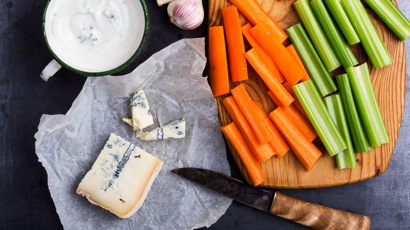 Blue cheese dip sauce with celery and carrot sticks