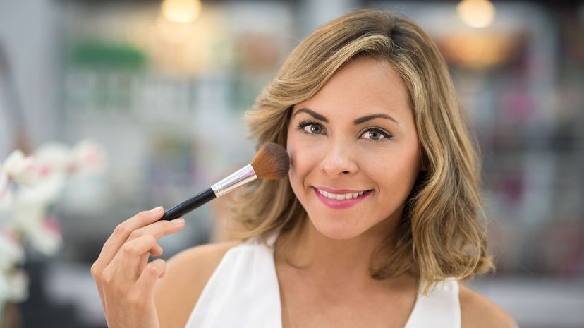 Woman applying blush with a brush