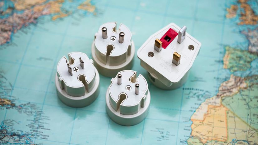 Travel plug adapters on world map