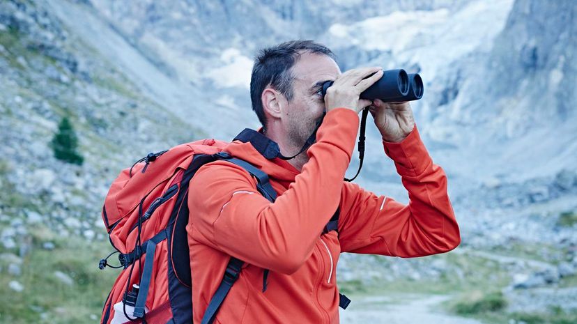 Hiker using binoculars, Mont Cervin, Matterhorn, Valais, Switzerland