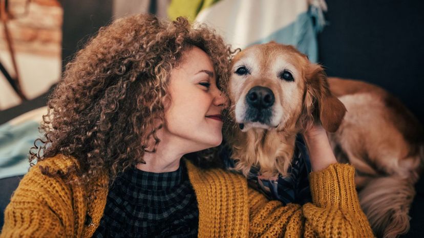 Woman Cuddling Golden Retriever