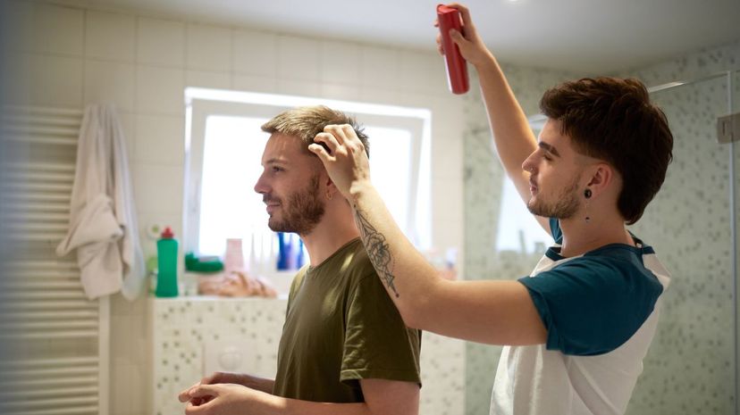 Couple using hairspray