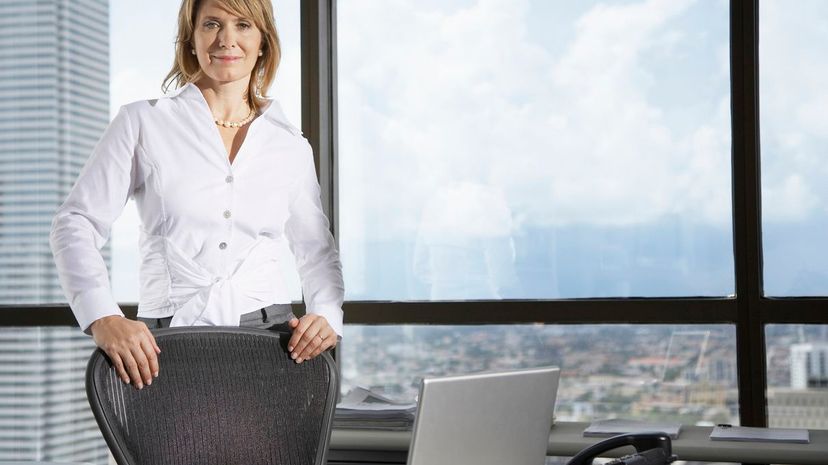 Businesswoman in office by large windows