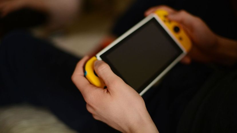 Young man holding game console