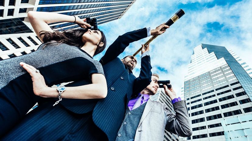 Business team with spyglass and binoculars looking for new opportunities