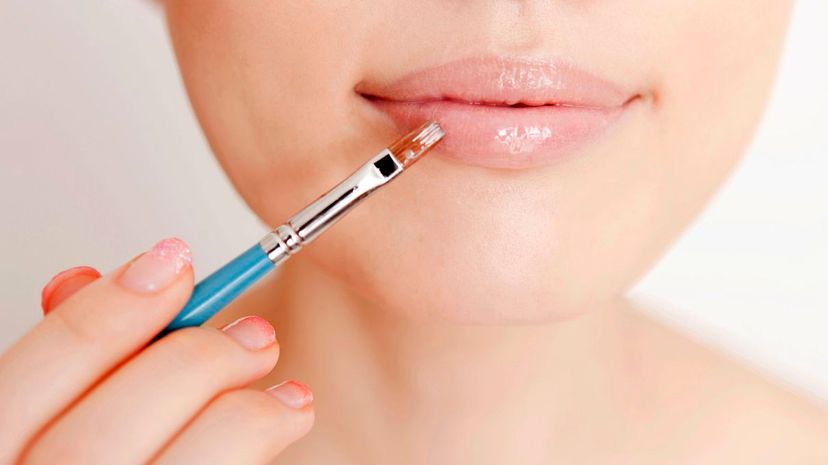Applying lipstick with brush