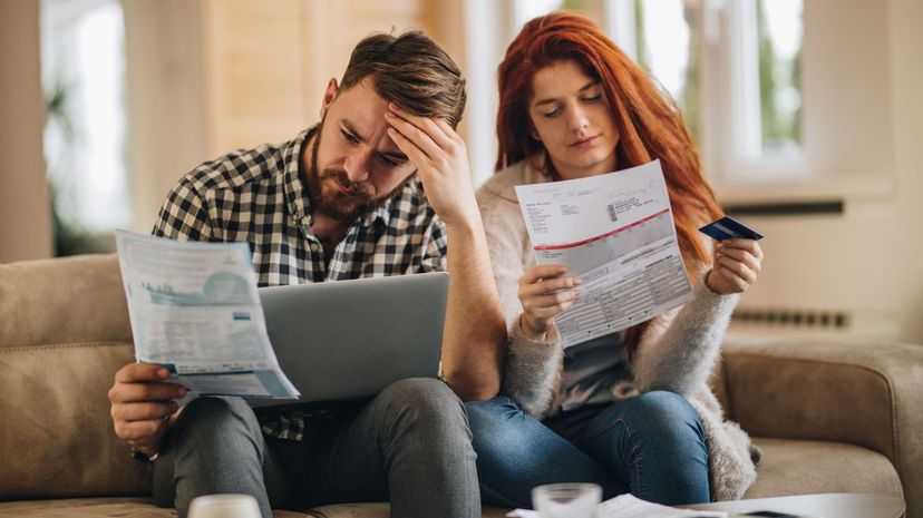 Worried couple look at bills