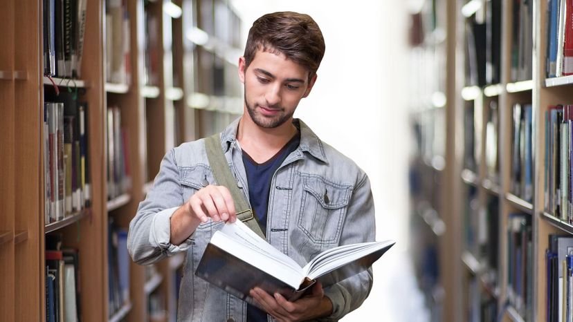 Young man reading in library