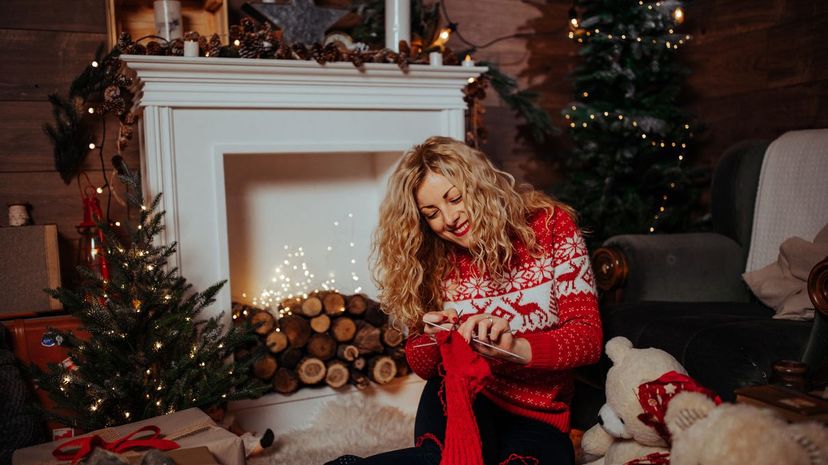 young woman knitting Christmas sock