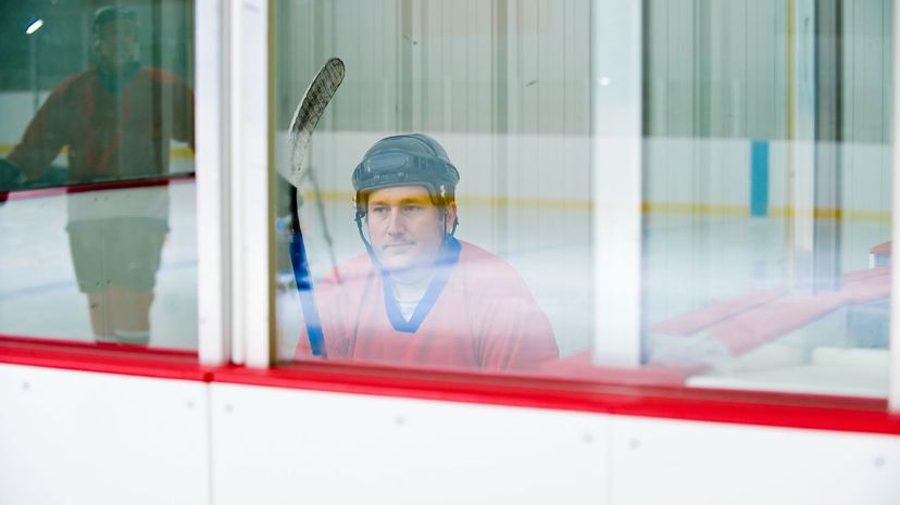 Hockey player sitting in penalty box