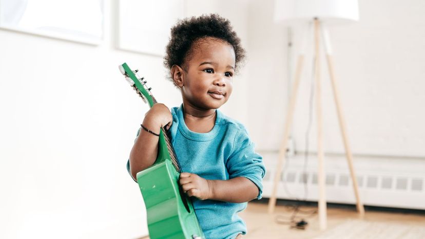 Toddler Holding Guitar