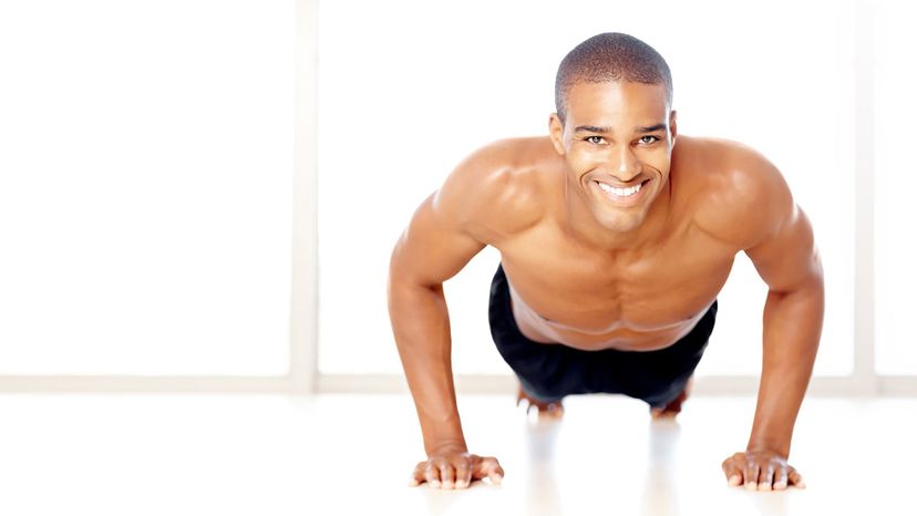 handsome man dark skin pushups shirtless