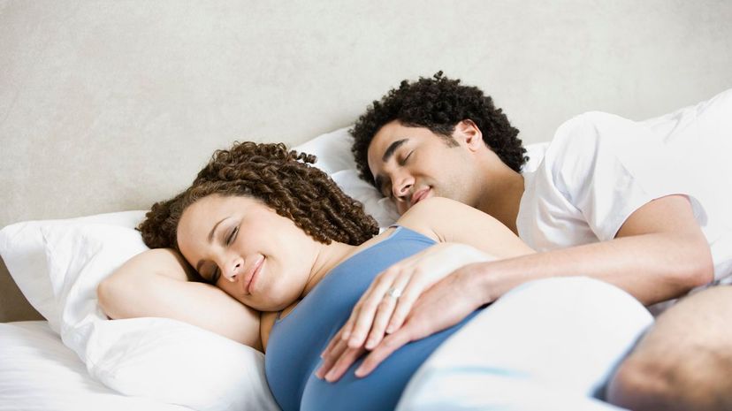 Spooning pregnant couple