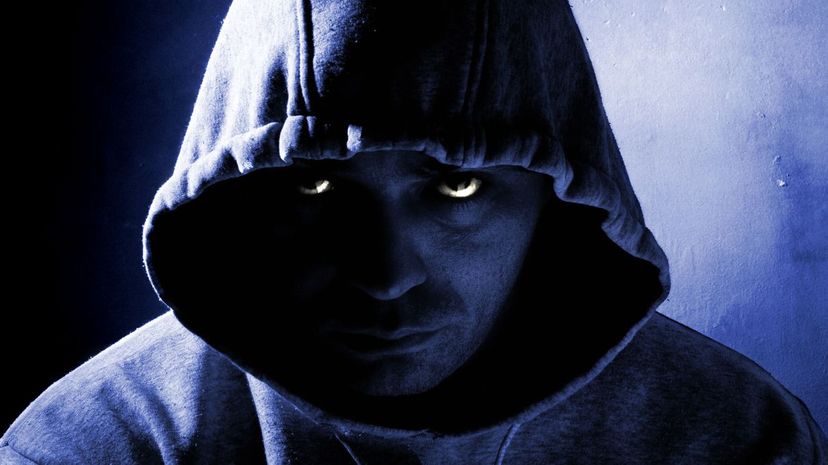 Dangerous man wearing hooded jacket at night