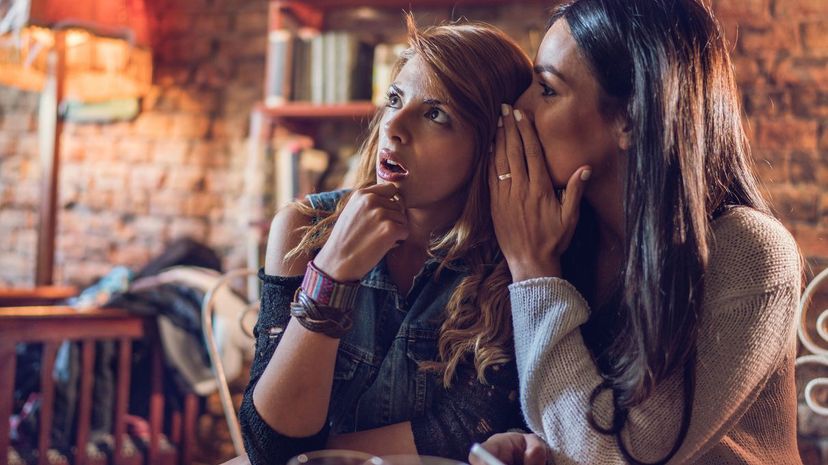 Woman telling friend secret